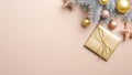 Xmas banner mockup with gold Christmas gift box and decorations on pastel beige background. Flat lay silver pine tree branch with Royalty Free Stock Photo