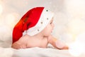 Xmas card with cute baby girl with santa hat on beige airy briht background with copy space