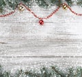 Xmas card. Old wooden Christmas background. Fir branches. Gold and red baubles. Red garlands. Top view. Space for your text. Royalty Free Stock Photo