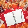 Xmas card, red background with stars. Notebook for your text. Fir branches with red balls. Top view