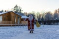 Xmas, cold, December. Santa Claus going with a bag of gifts in the winter on snow-covered field