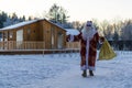 Xmas, cold, December. Santa Claus going with a bag of gifts in the winter on snow-covered field