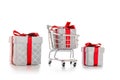 Xmas gift. Trolley cart for supermarket with christmas or birthday gift box isolated on white background. Creative idea for