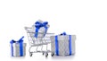 Xmas gift. Trolley cart for supermarket with christmas or birthday gift box isolated on white background. Creative idea for