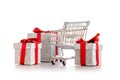 Xmas gift. Trolley cart for supermarket with christmas or birthday gift box isolated on white background. Creative idea for