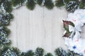 Xmas greeting card, White Christmas wreath in a frame of Christmas tree branches on a wooden background Royalty Free Stock Photo