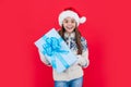 xmas holiday. amazed santa teen girl with xmas present in studio. teen girl