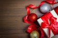 Xmas holiday celebration. New Year 2020. white gift box tied in a red ribbon bow placed. Christmas ball. on a wooden background Royalty Free Stock Photo