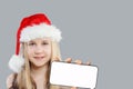 Xmas kid Santa with cellphone. Girl in Santa hat Royalty Free Stock Photo