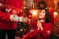 Xmas, male person makes gift to beautiful woman
