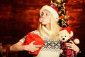 Xmas mood. Christmas preparation. All she wants for christmas. Cheerful woman. Woman got teddy bear toy present. Santa