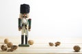 Xmas nutcracker soldier and nuts on wooden table