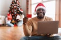 Xmas Online Shopping. Smiling guy using laptop showing credit card Royalty Free Stock Photo