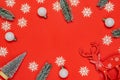 Xmas pattern. White snowflakes, fir tree, silver balls in Christmas composition on red background for greeting card. Flat lay, top Royalty Free Stock Photo