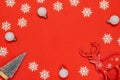 Xmas pattern. White snowflakes, fir tree, silver balls in Christmas composition on red background for greeting card. Flat lay, top Royalty Free Stock Photo