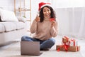 Xmas Shopping. Black lady using laptop holding credit card Royalty Free Stock Photo