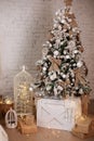 Xmas tree decorated with toys, balls and lights garlands. Beautiful decorated Christmas tree with gifts. New year decorations conc Royalty Free Stock Photo