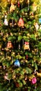 A christmas tree with little decorated silk bags.