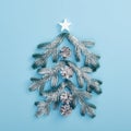 Xmas tree shape made of snowy fir branch and pinecone Royalty Free Stock Photo