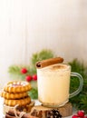 Xmas vertical image with soft focus with traditional desserts eggnog in cup and ginger cookies.