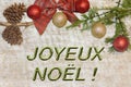 Christmas postcard for greetings. Metallic letters on natural wood background. Red, golden and white Xmas wallpaper