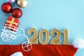 Xmas, winter, new year concept - Blue Christmas background with red gold and white tree toys, Santa hat, 2021 number Royalty Free Stock Photo