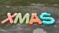Xmas word from colourful wooden stick on mossy table background Royalty Free Stock Photo