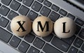 XML - acronym on wooden balls on laptop keyboard background