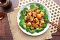 Stir fried Scallops with mushroom in  XO sauce of a white plate garnished with broccoli - Top view Chinese food on wood table Royalty Free Stock Photo
