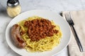 spaghetti top with a hmeat sauce and parsley