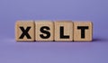 XSLT - acronym on wooden cubes on a lilac background Royalty Free Stock Photo