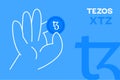 Hand holding Tezos coin, crypto currency editable vector. Flat design XTZ crypto token banner Royalty Free Stock Photo