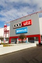 XXXLutz Mobelix corporation logo on supermarket building
