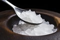 xylitol natural sweetener crystals on a metal spoon