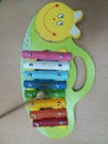 Xylophone educational toy for children in the shape of a caterpillar that has been used for years is played with a wooden beater Royalty Free Stock Photo