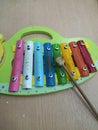 Xylophone educational toy for children in the shape of a caterpillar that has been used for years is played with a wooden beater Royalty Free Stock Photo