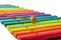 Xylophone musical instrument with wooden bars painted in rainbow and maleta colors on a white isolated background Royalty Free Stock Photo