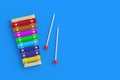 Xylophone with sticks on blue background. Kids toy. Preschool education Royalty Free Stock Photo