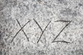 Xyz letters on sand background