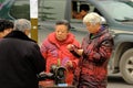 Yaan China-Four old men playing poker cards on the street