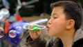 Yaan China-A little boy is blowing soap bubbles