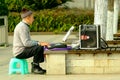 Yaan China-An old man is playing electronic organ Royalty Free Stock Photo