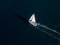 A yacht with all sails set races across the sea, propelled by the wind. Aerial view Royalty Free Stock Photo