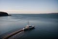 A yacht anchored in a quiet coastal bay