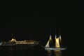 Yacht approaching the harbor at night Royalty Free Stock Photo