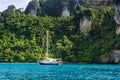 Yacht in beautiful bay near Koh Phi Phi Don in Andaman sea. Location: island Koh Phi Phi Don, Krabi, South Thailand.  Artistic Royalty Free Stock Photo