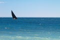 Yacht with black sail racing in the azure Mediterranean Sea