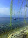 Yacht at blue lake, spring, Lago di Garda, Italy Royalty Free Stock Photo