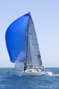 Yacht With Blue Sail Competes In Team Sailing Event