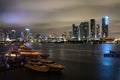 Yacht or boat next to Miami downtown. Beautiful colorful city of Miami Florida skyline and bay with night clouds. Royalty Free Stock Photo